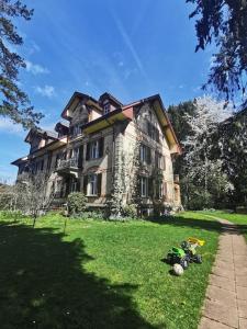 an old house with a pile of balls in front of it at Beautiful central Apartment in Bern