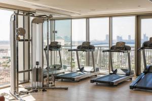 a gym with a bunch of treadmills in a building at 2bdr - Pool - Emaar - Creek Harbour in Dubai
