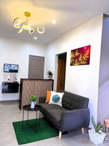 a living room with a couch and a table at HOST HOMESPACE in Tacloban
