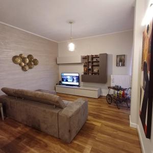 a living room with a couch and a flat screen tv at NSM La Vie en Rose appartamento con box e terrazzo in Foggia +34 photos
