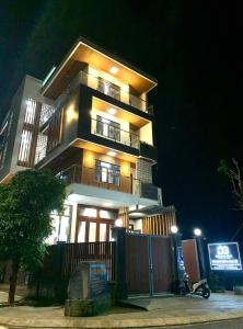 a tall building with lights on at night at Đoàn Gia Luxury House in Pleiku