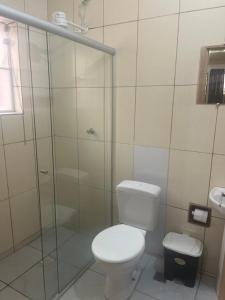 a bathroom with a toilet and a glass shower at H POUSADA DO BENTO in Aparecida +10 photos