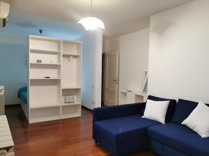 a living room with a blue couch and a white cabinet at Affittacamere Guerrero Rooms in Trieste +34 photos
