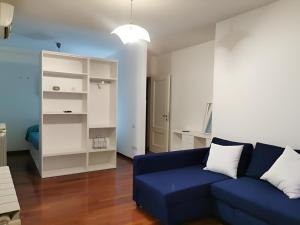 a living room with a blue couch and a white cabinet at Affittacamere Guerrero Rooms in Trieste