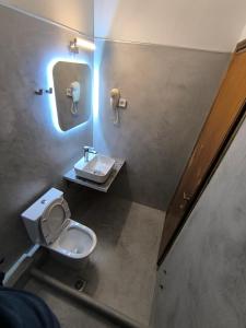 a bathroom with a toilet and a sink at House Mistral in Neos Marmaras