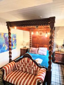 a bedroom with a four poster bed with a couch at Magpie 6 HuntersMoon-Warminster-longleat-Bath in Warminster