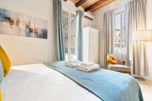 a bedroom with a bed with towels on it at Lodging Apartments Beach Studio 11 in Barcelona