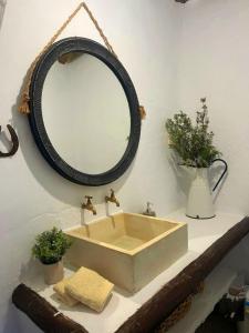 a bathroom with a sink and a mirror on the wall at Casa Juanillo in Miller