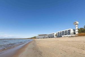 a building on the beach next to the water at Amazing sea views - W207 in Tallinn