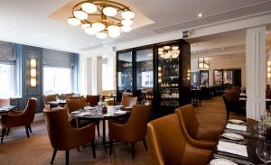 a restaurant with tables and chairs and a chandelier at The Gainsborough Bath Spa - Small Luxury Hotels of the World in Bath