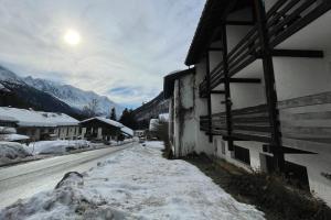 a building with snow on the side of a street at Studio de Balme - Happy Rentals in Chamonix