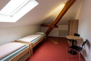 a room with two bunk beds and a table at Kreuzlingen Youth Hostel in Kreuzlingen