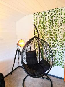 a hanging chair in a room with a plant at Magpie 6 HuntersMoon-Warminster-longleat-Bath in Warminster