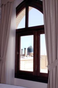 an open window with a view of a mosque at L'Argamak in Samarkand