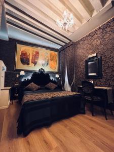 a bedroom with a bed and a desk and a television at Hotel al Graspo de Ua in Venice