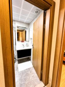 a bathroom with a sink and a mirror at Green Cinar Apart in Uzungöl +107 photos