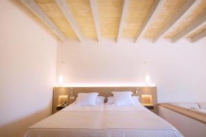 a bedroom with a bed with a wooden ceiling at Casa Rural Son Bernadinet in Campos