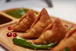 a plate of food with a group of wontons at Hotel In Max Hospital-Malviya Nagar in New Delhi