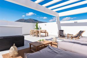 a living room with a couch and a table at Casa Isa - Luxury Penthouse Seaview in Estepona