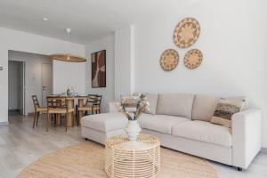 a living room with a couch and a table at Casa Isa - Luxury Penthouse Seaview in Estepona