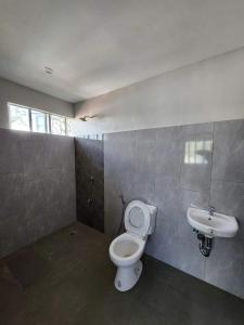 a bathroom with a toilet and a sink at HOST HOMESPACE in Tacloban