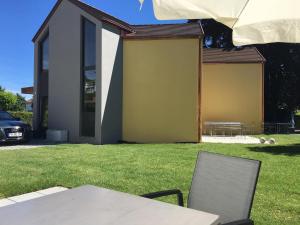 a table and chairs in the yard of a house at Bodenseeapartments Kunst & Design in Immenstaad am Bodensee