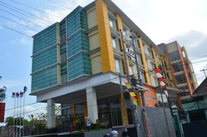 a large building with glass windows on a city street at EDU Hostel in Yogyakarta