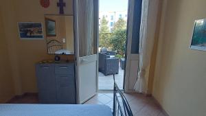 a bedroom with a door open to a balcony at Casetta Pinetamare Tropea in Tropea