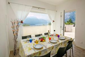 a dining room table with a view of the mountains at Casa Renè in Tenno