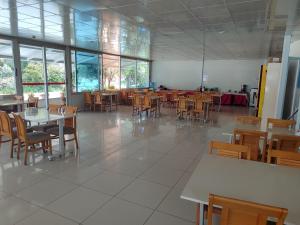 a dining room with tables and chairs and windows at HOTEL YAGMUR in Anamur