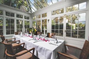 a dining room with a table in a room with windows at Dresdner Hof in Zittau