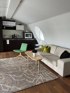 a living room with a couch and a table at DA Hotel Apartments in Gothenburg