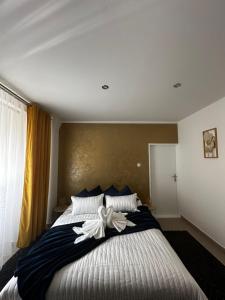 a bedroom with a large bed with a bow on it at Apartment Reduta Celebration in Poprad