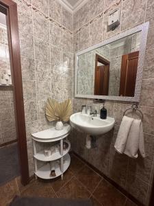 a bathroom with a sink and a mirror at Apartment Reduta Celebration in Poprad
