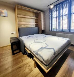 a bedroom with a large bed in a room at Zaruskiego 2 in Ustka