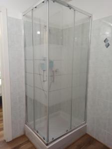 a shower with a glass door in a room at La Maisonette in Sori +10 photos