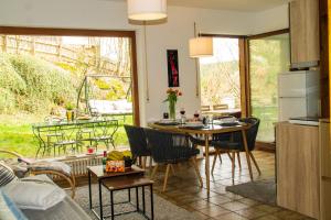 a kitchen and living room with a table and chairs at Ferienwohnung in Schönwald Schwarzwald in Schönwald