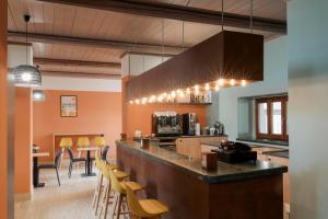 a kitchen with a bar and a dining room at Hotel Altevie in Guardiagrele