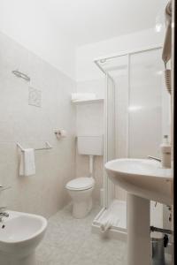 a white bathroom with a toilet and a sink at Hotel Altevie in Guardiagrele