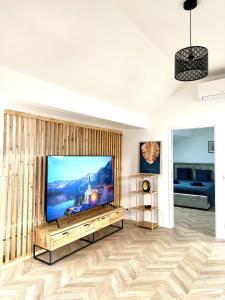 un soggiorno con una grande TV a schermo piatto di Magnifique Appartement Neuf, 5 Min Orly - Climatisé a Paray-Vieille-Poste