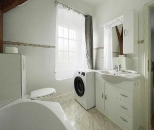 a white bathroom with a sink and a toilet at Apartments-Alt-Marzahn in Berlin