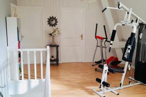 a room with a gym with a treadmill at La Maraitière in Guînes