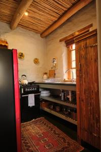 Il comprend une cuisine équipée d'un réfrigérateur et d'une cuisinière. dans l'établissement Olive Stone Farm Cottages, à Montagu
