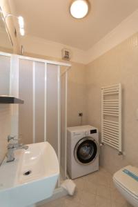 a bathroom with a washing machine and a washer at Appartmento S3M in Isola Albarella