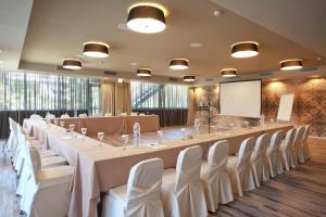 a large conference room with a long table and chairs at Congo Palace in Athens