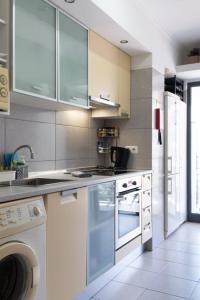 a kitchen with a sink and a stove top oven at GuestReady - A sunny delight in Funchal in Funchal