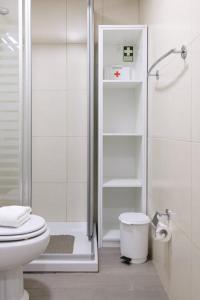 a white bathroom with a shower and a toilet at GuestReady - An amazing blue ocean view in Funchal