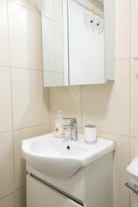 a white bathroom with a sink and a cabinet at GuestReady - An amazing blue ocean view in Funchal
