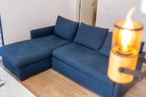 a blue couch with a candle on top of it at GuestReady - Panoramic Mountain Escape in São Vicente