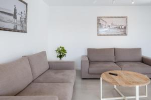 a living room with a couch and a table at GuestReady - A delightful stay in Porto Santo in Campo de Baixo